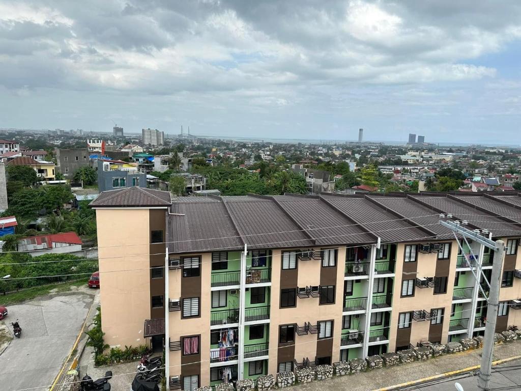 an apartment building with a metal roof in a city at Cebu City 2 Bedroom Condo Unit-WIFI-A/C-Hot Shower (U404) in Cebu City