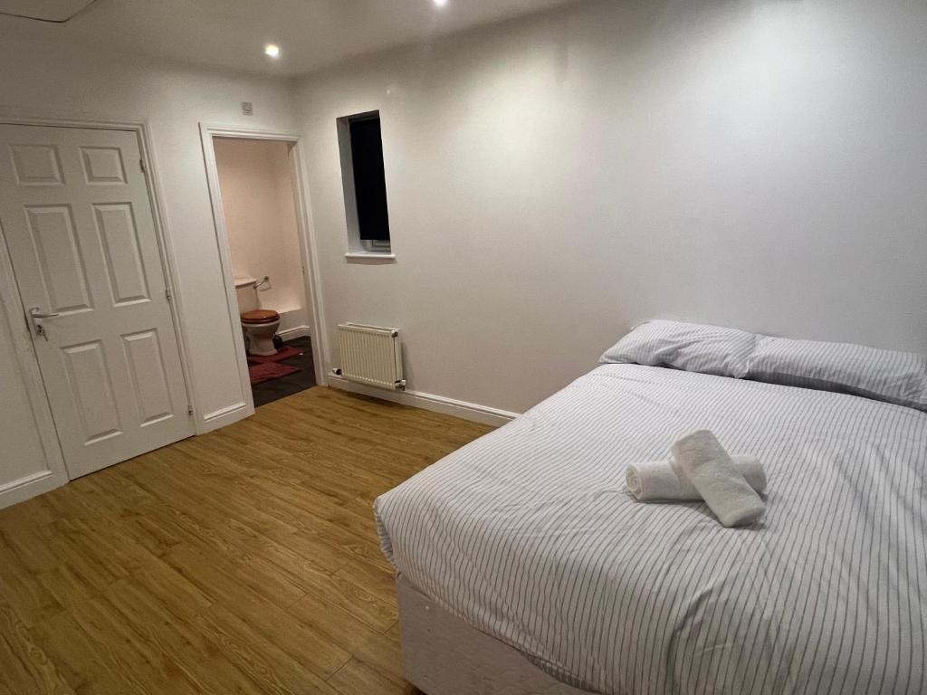 a bedroom with a bed with a towel on it at South Cottage in Hardingstone