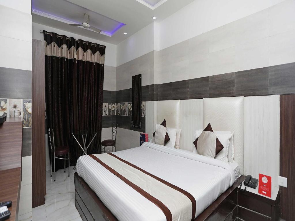 a bedroom with a large bed in a room at Collection O Hotel RV Palace in Agra