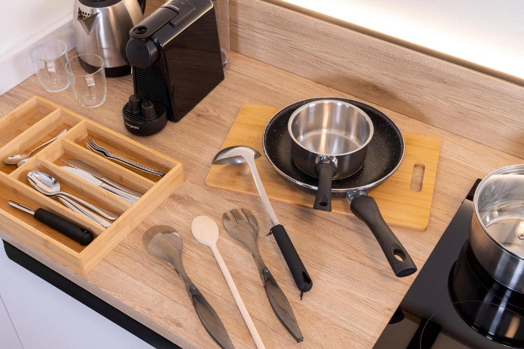 a wooden cutting board with utensils on a counter at Hôtel Du Dragon in Strasbourg