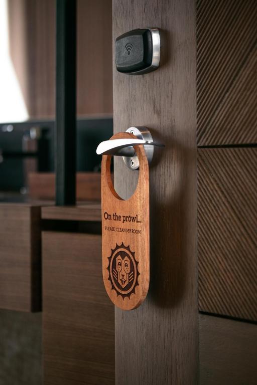 a wooden door with a padlock on the door at The Funny Lion - Puerto Princesa in Puerto Princesa City