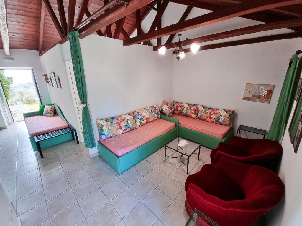 a living room with two couches and two chairs at Forestata Village in Lixouri