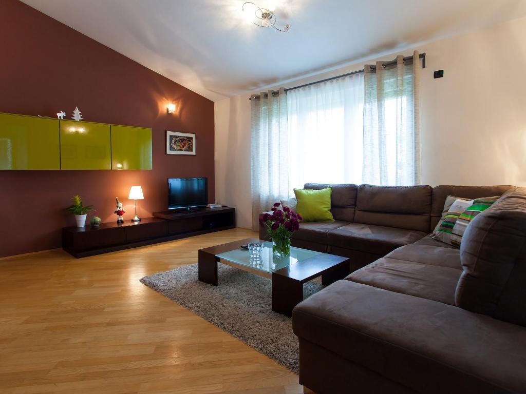 a living room with a couch and a coffee table at Comfort Premium Apartment in Poreč