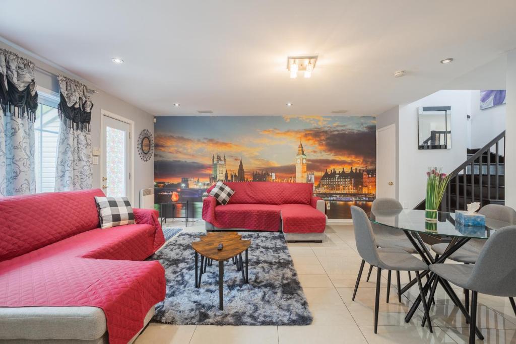 a living room with a red couch and a table at Amazing 4-Bedrooms MONTREAL in Montréal