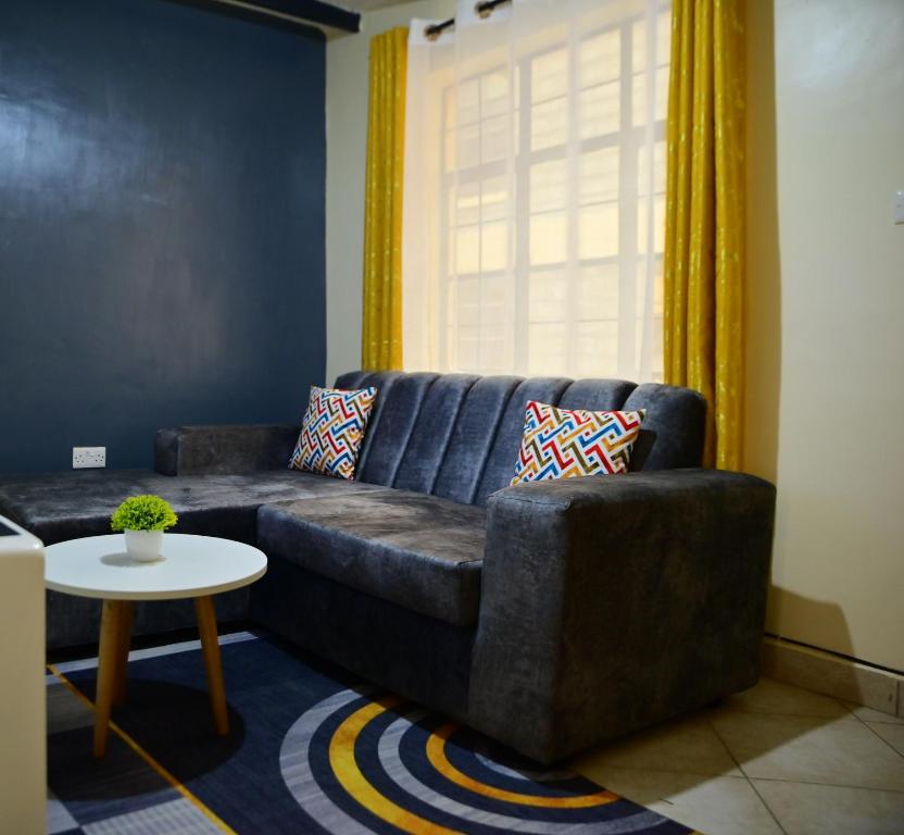 a living room with a couch and a table at Elegantstays in Nairobi