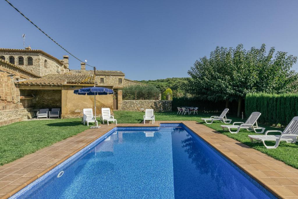 a swimming pool in the yard of a house at Mas Cases in Girona