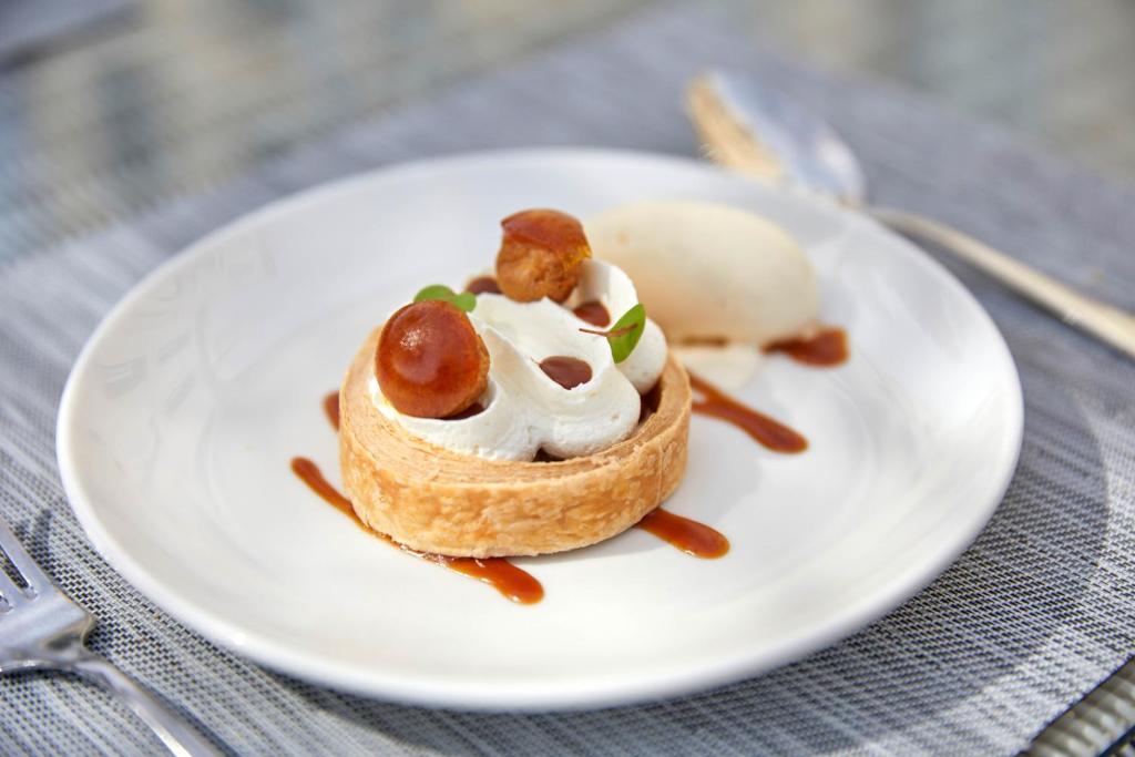 a white plate with a dessert on a table at Château Les Carrasses in Capestang