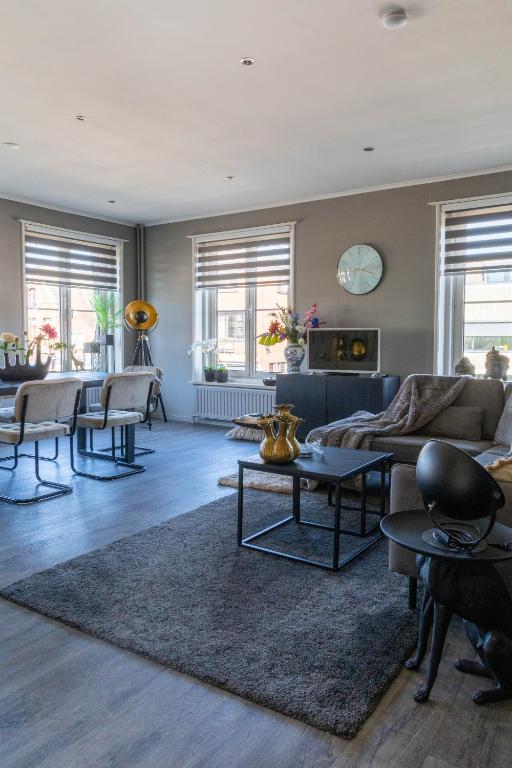 a living room with a couch and a table at Mart9 City Loft in Zevenbergen