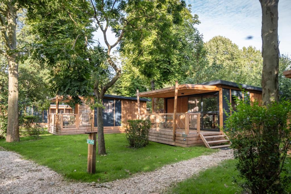 a log cabin in the woods with trees at CityKamp Paris in Paris