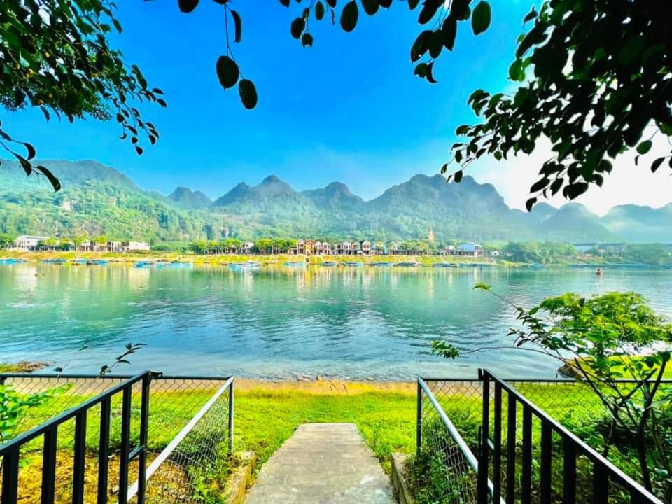 a view of a lake with mountains in the background at Carambola Bungalow in Phong Nha