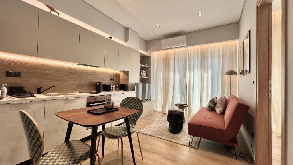 a kitchen and living room with a table and chairs at Jack, 2 people, renovated stylish apartment in Athens