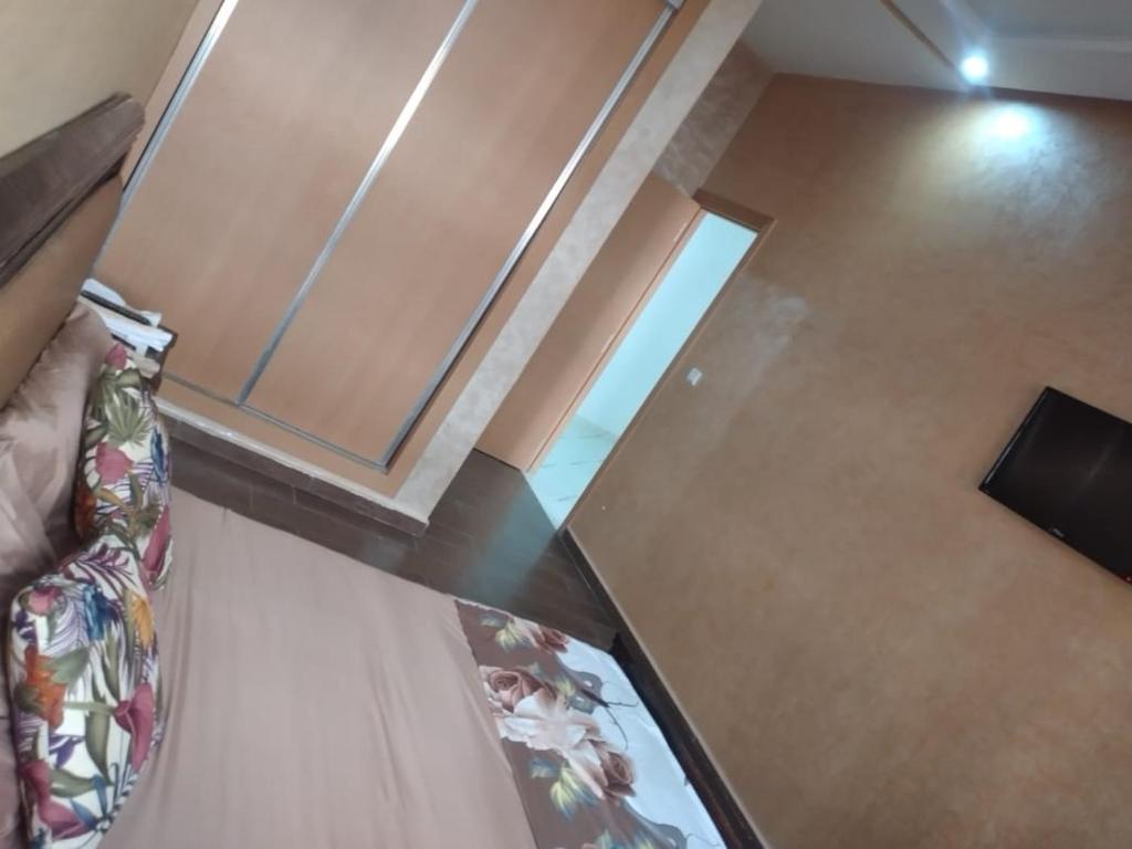 a view of a room with a bed and a window at Airport M V chambre stay in Deroua