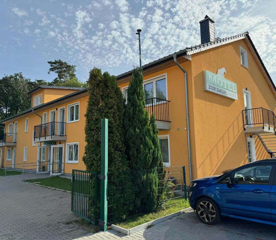 um carro azul estacionado em frente a um edifício em Motel Zur Dachsbaude em Wandlitz