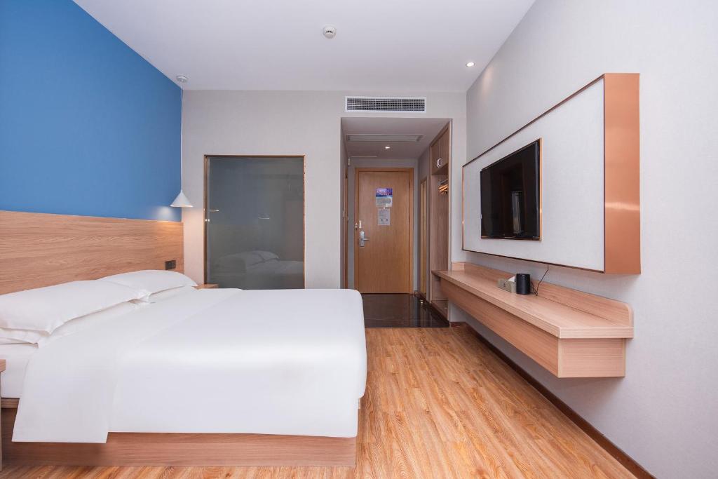 Postel nebo postele na pokoji v ubytování Future Shangju Hotel