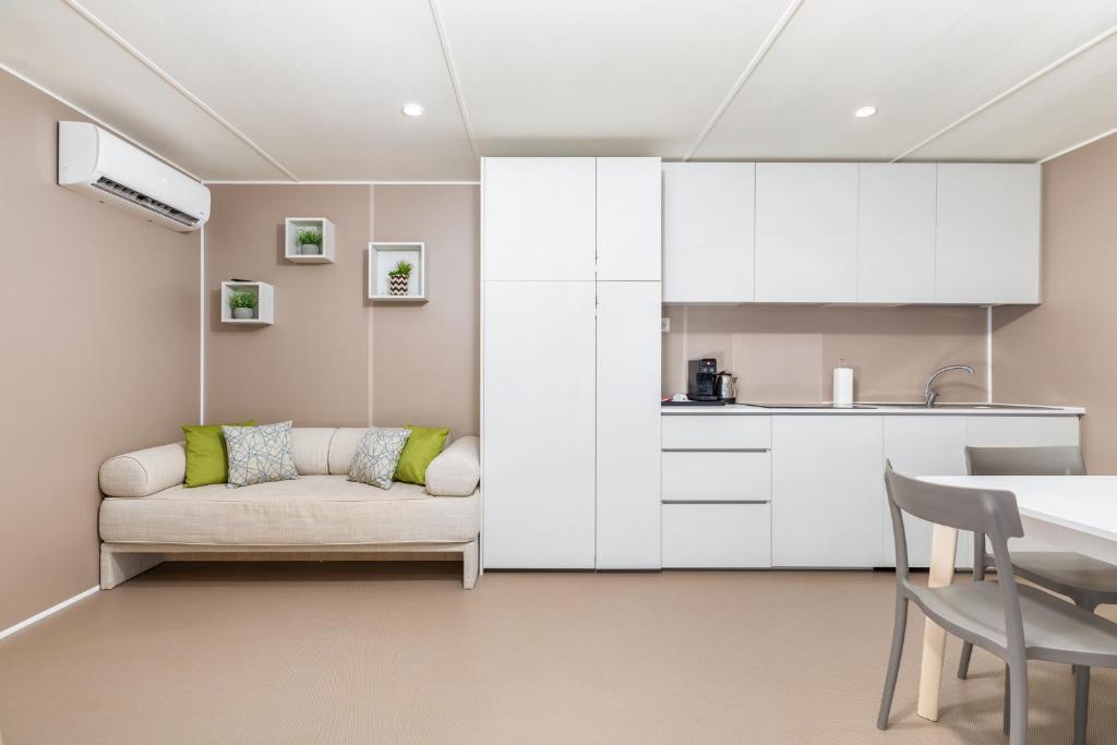 a living room with a couch and a table at Arena Stoja Camping Homes in Pula