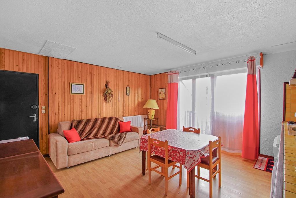 a living room with a couch and a table at Appartement CERF in La Llagonne