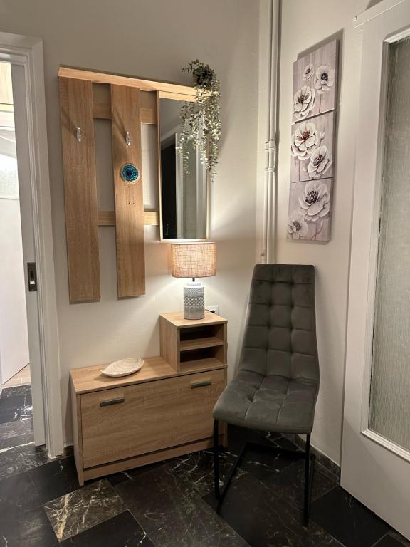 a room with a chair and a dresser and a mirror at Central Piraeus 2 in Piraeus