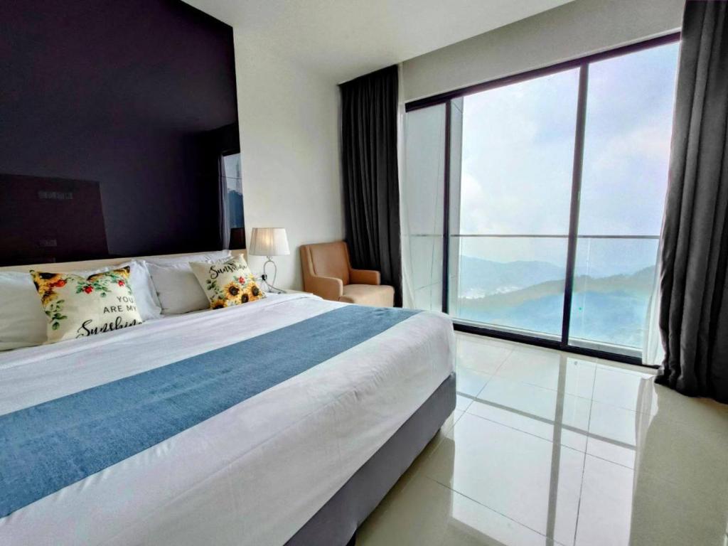 a bedroom with a large bed and a large window at GentingPeak8pax3BR110@IonDelemen in Genting Highlands