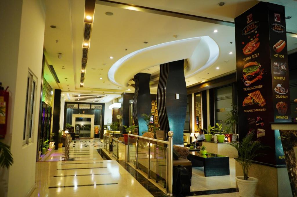 a lobby of a building with a restaurant at The Vaishnavi in Deoghar
