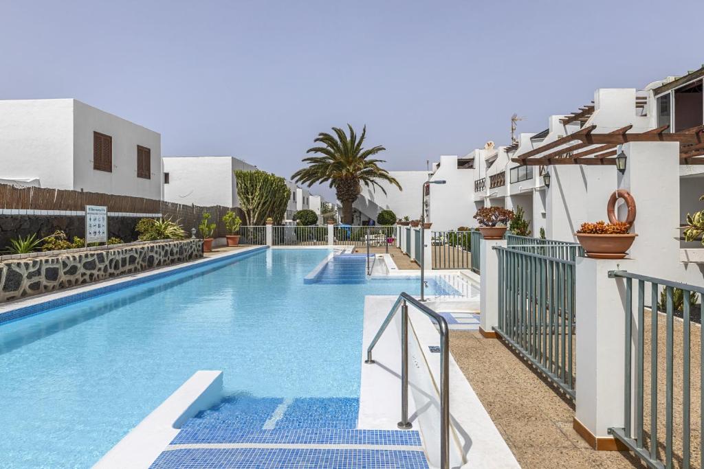 a swimming pool in a hotel with blue stairs at Casa Aldea in Puerto del Carmen