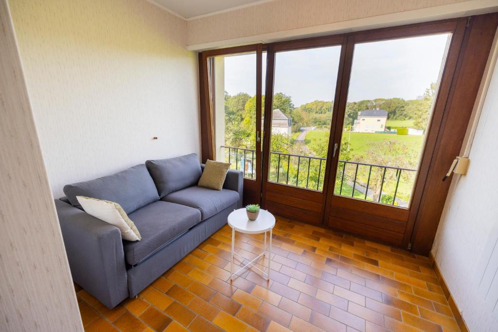 a living room with a couch and a large window at Good connection Airport & City in Luxembourg