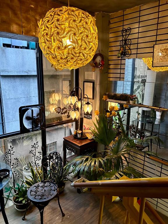 a room with potted plants and a large light fixture at Taipei Triple Tiger Inn in Taipei