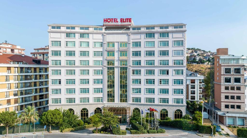a white building with a hotel sign on top of it at Elite Hotel Dragos in Istanbul