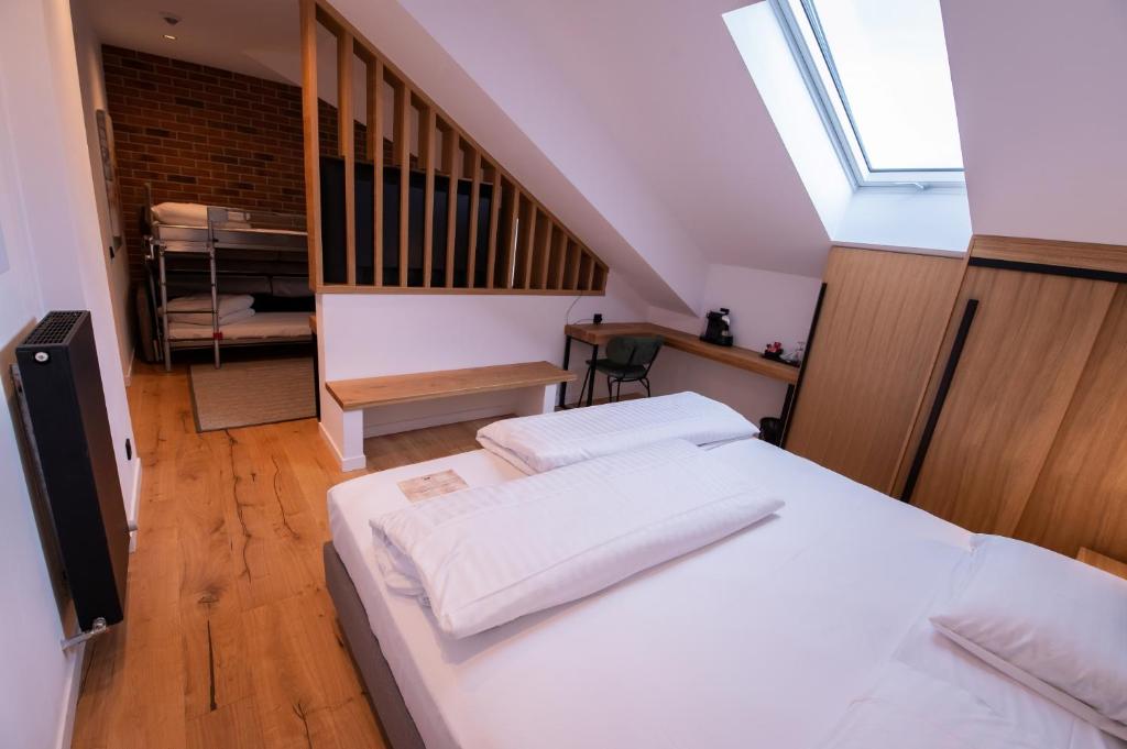 a bedroom with two beds and a staircase at Caro Hotel in Bucharest