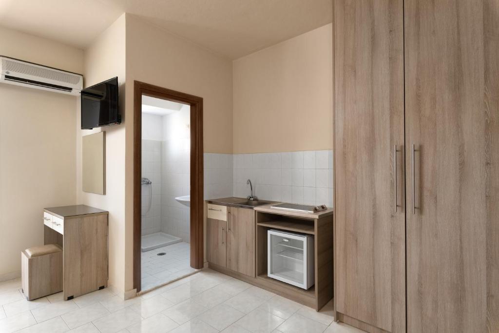 a small bathroom with a sink and a toilet at Rose Hotel Faliraki in Faliraki