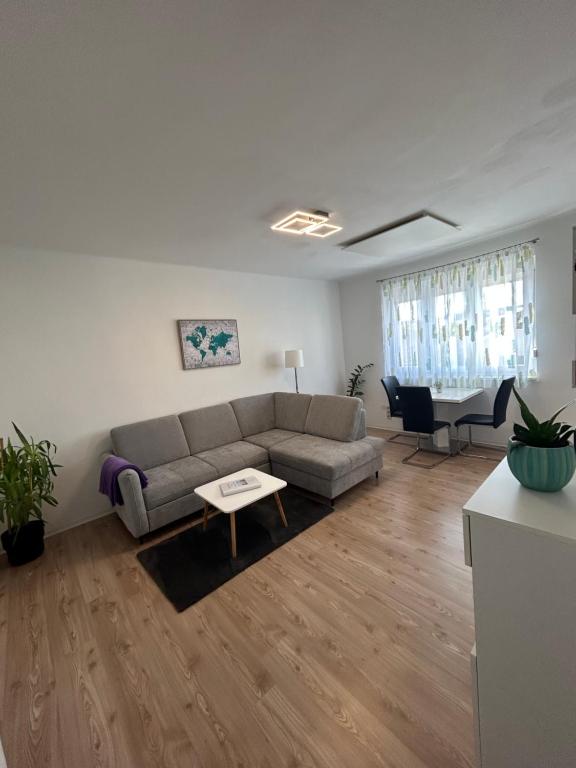 a living room with a couch and a table at City Apartment Tulln in Tulln