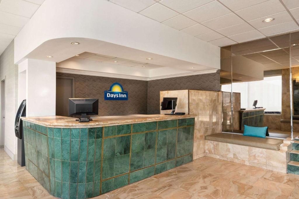 a lobby of a dental office with a reception desk at Days Inn by Wyndham Miami Airport North in Miami