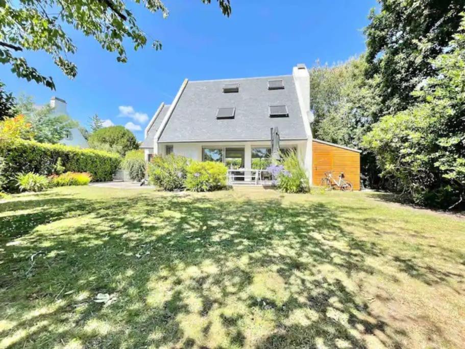 a house with a large yard in front of it at La villa des Dunes - 80m de la plage/paddle/vélos in Fouesnant