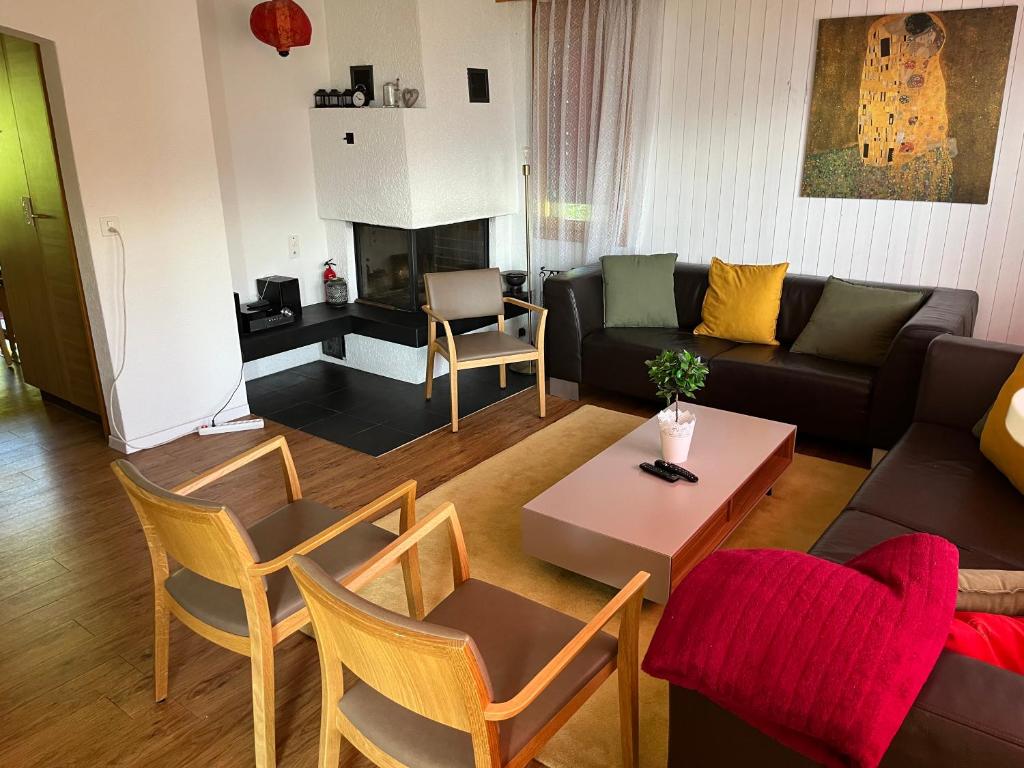 a living room with a couch and a table at AmdenLodge - Gardens Chalet in Amden