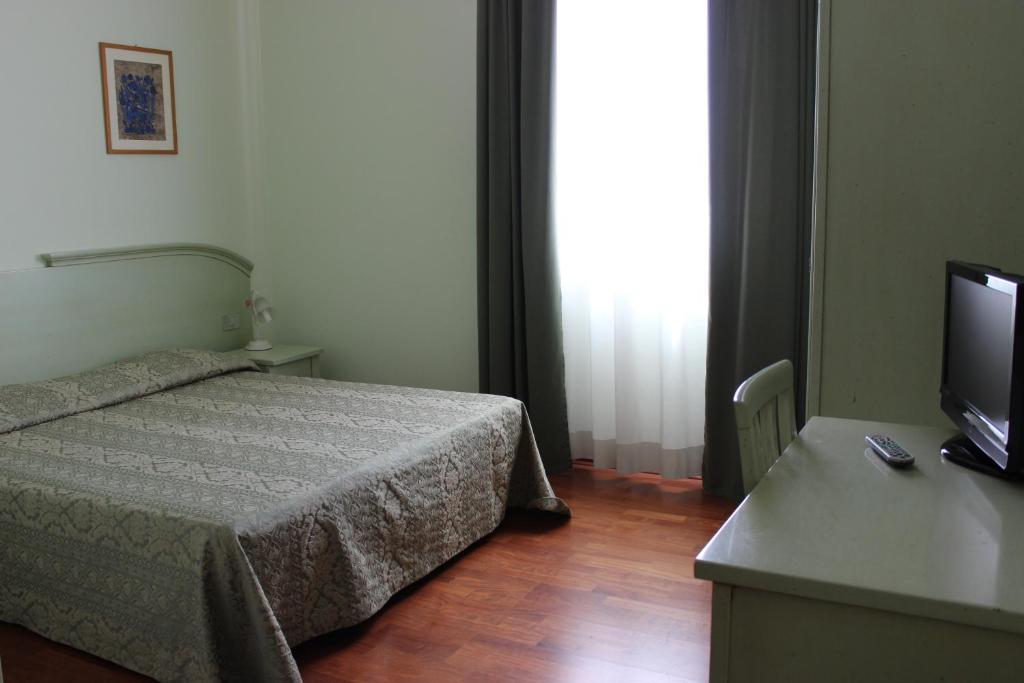 Postel nebo postele na pokoji v ubytování Hotel Altieri