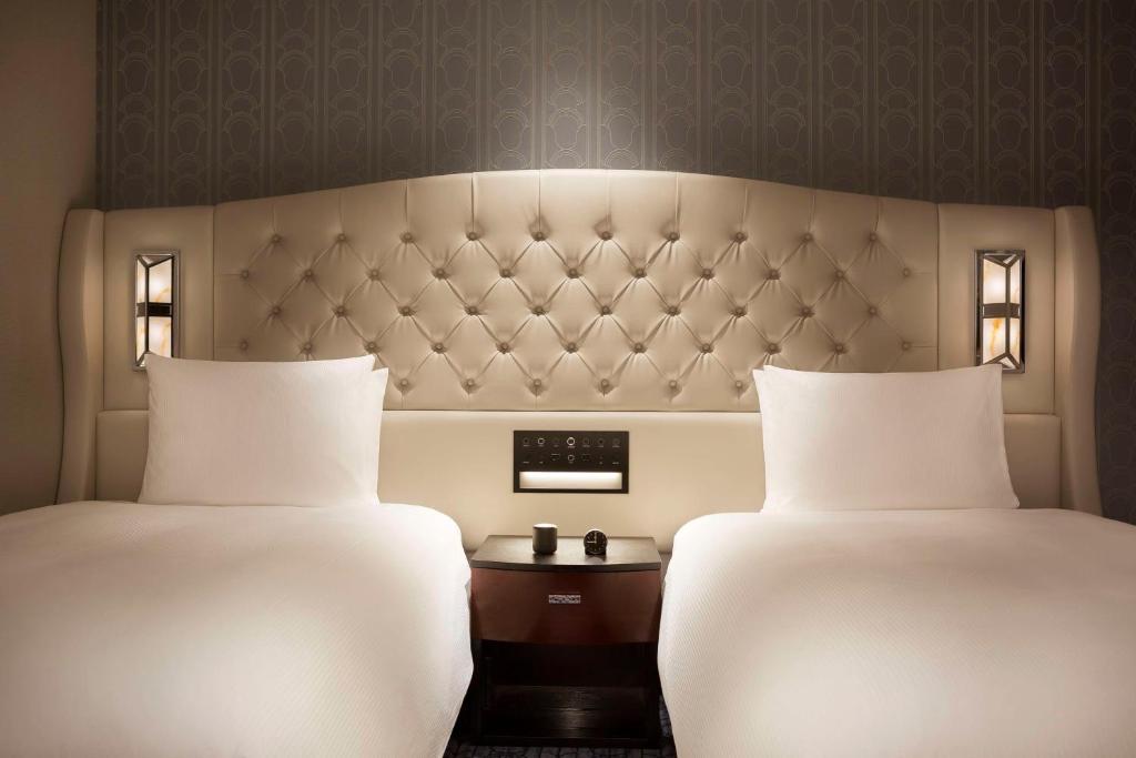 Postel nebo postele na pokoji v ubytování Hilton Yokohama