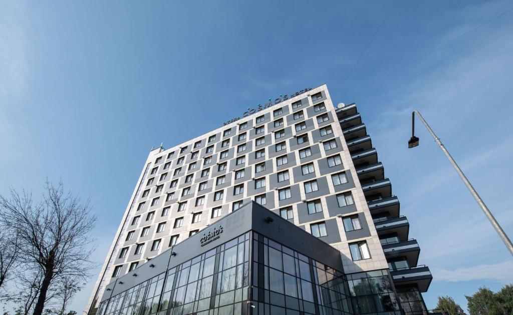 a tall hotel building with a blue sky in the background at Cosmos Yaroslav Hotel, a member of Radisson Individuals in Yaroslavl