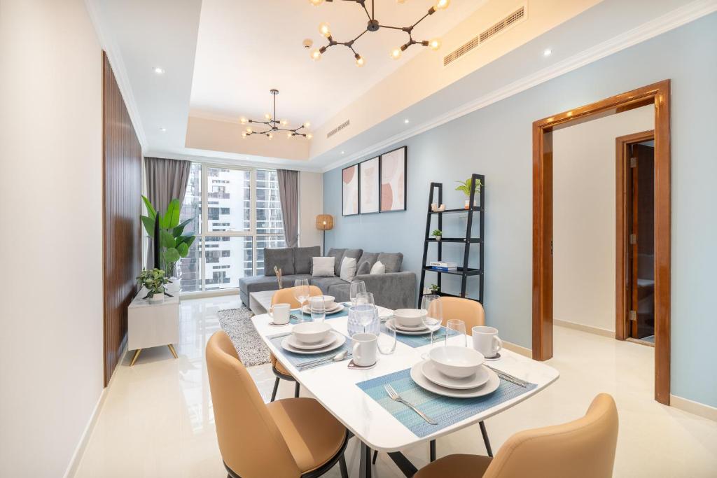 a dining room and living room with a table and chairs at Heaven Crest Holiday Homes Downtown - Studio, 1 & 2 Bedroom Suites beside Dubai Mall and Burj Khalifa in Dubai