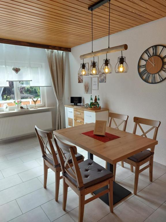 a dining room with a wooden table and chairs at Moderne Ferienwohnung - neu renoviert - ruhige Lage in Waldachtal