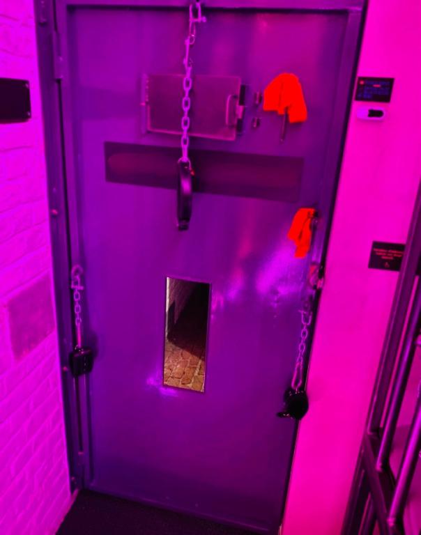 a purple door with a chain in a room at Secret Room votre LOVE ROOM coquine et insolite en espace privatif a Tournai in Tournai