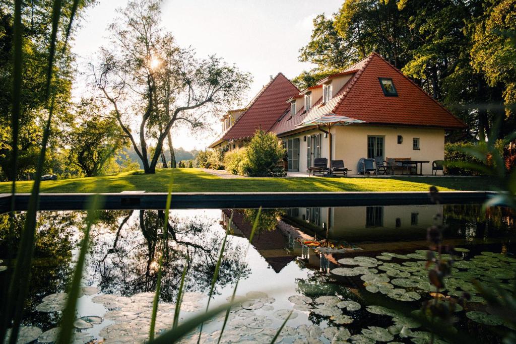 a house with a pond in front of it at Riedhof 2 in Egling