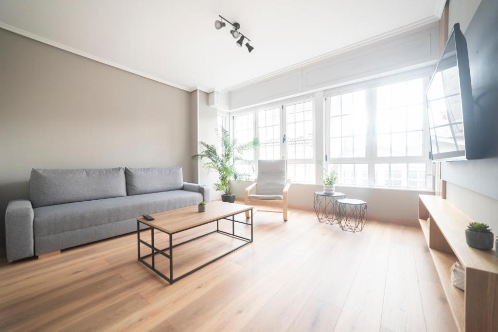 a living room with a couch and a table at Apartamento AN Sol “Ferrol” in Ferrol