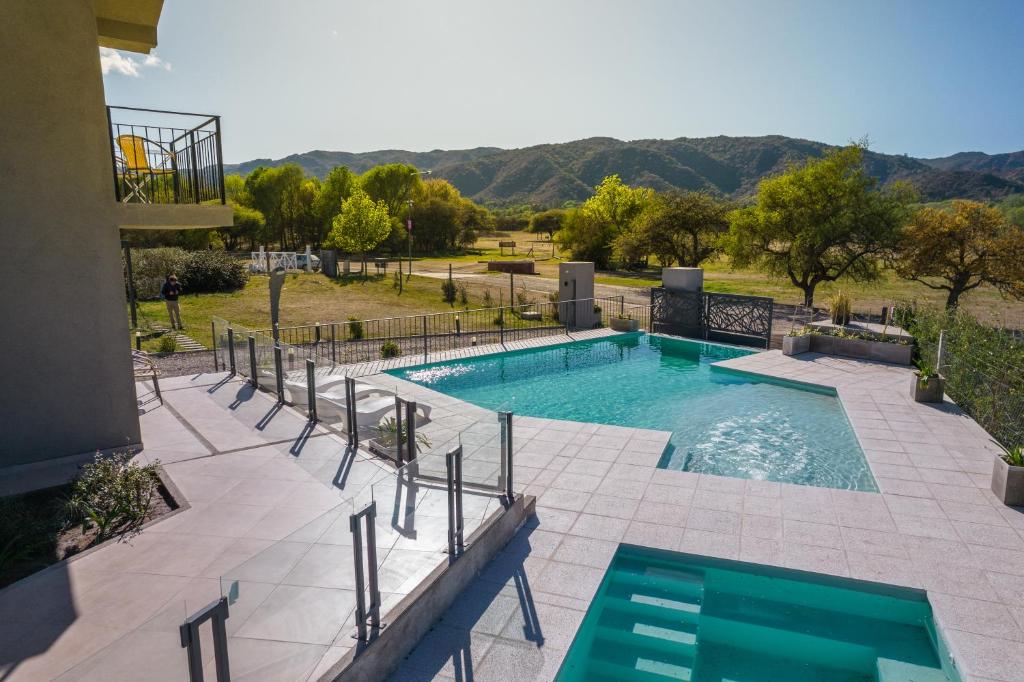 a swimming pool with a view of the mountains at Los Cóndores Aparts. in Villa General Belgrano