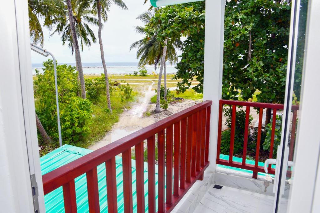 a balcony with a view of the beach at Empyrean Stay, Maldives in Thulusdhoo