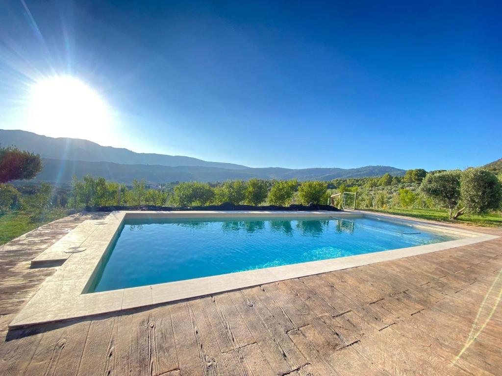 a swimming pool with a view of the mountains at ENTRESIERRAS Apartamentos rurales piscina 24h con barbacoa y espacio para eventos in Cazorla