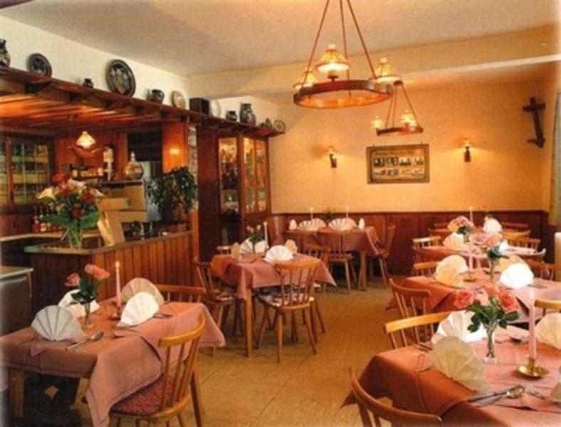 a restaurant with tables and chairs in a room at Bayerischer Hof in Amorbach