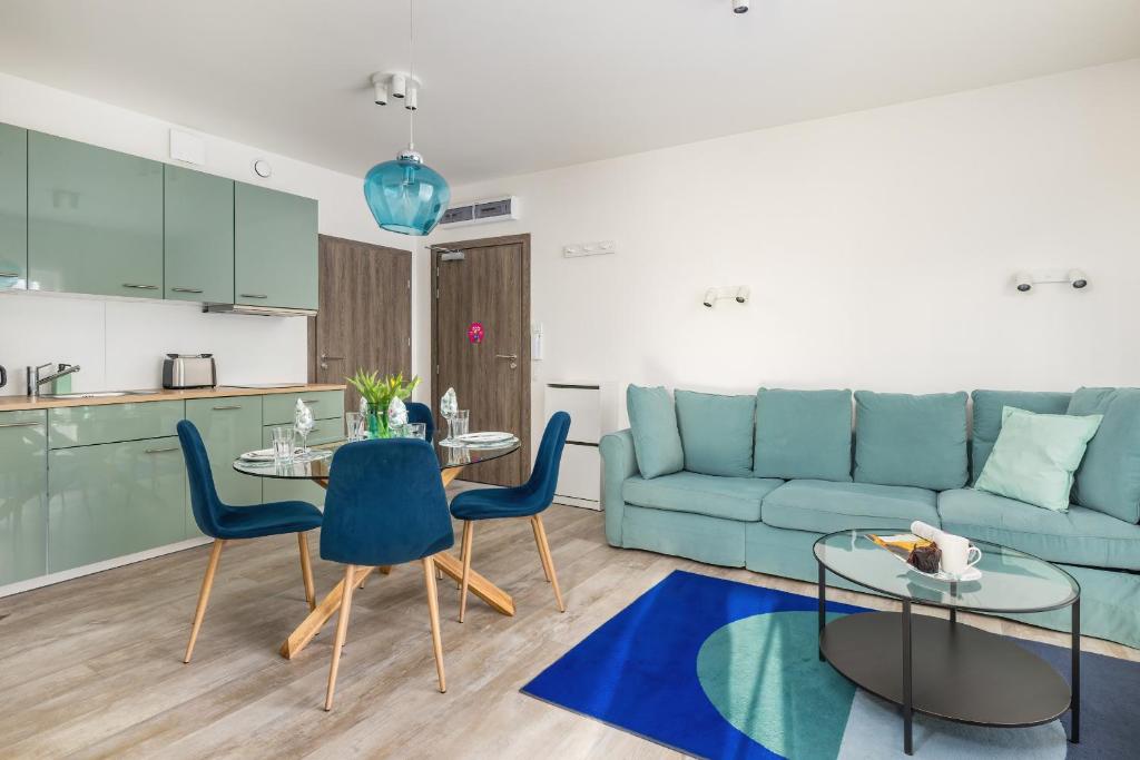 a living room with a couch and a table and chairs at Apartment Five Seas with Parking & Swimming Pool by Renters in Sianozety