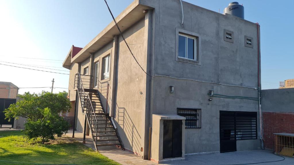 a building with a staircase on the side of it at Dtos El Descanso in Termas de Río Hondo