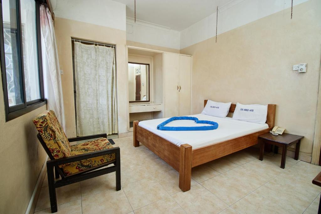 Postel nebo postele na pokoji v ubytování Mombasa Railway Gardens Hotel