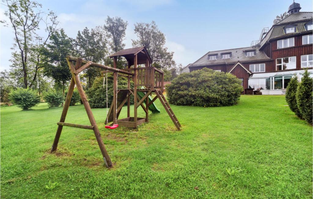a wooden playground in a yard with a house at Amazing Home In Oberharz With Wifi in Waldschlösschen