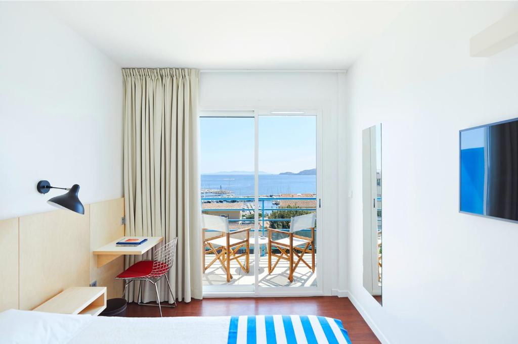 a hotel room with a view of a balcony at Hôtel California in Le Lavandou
